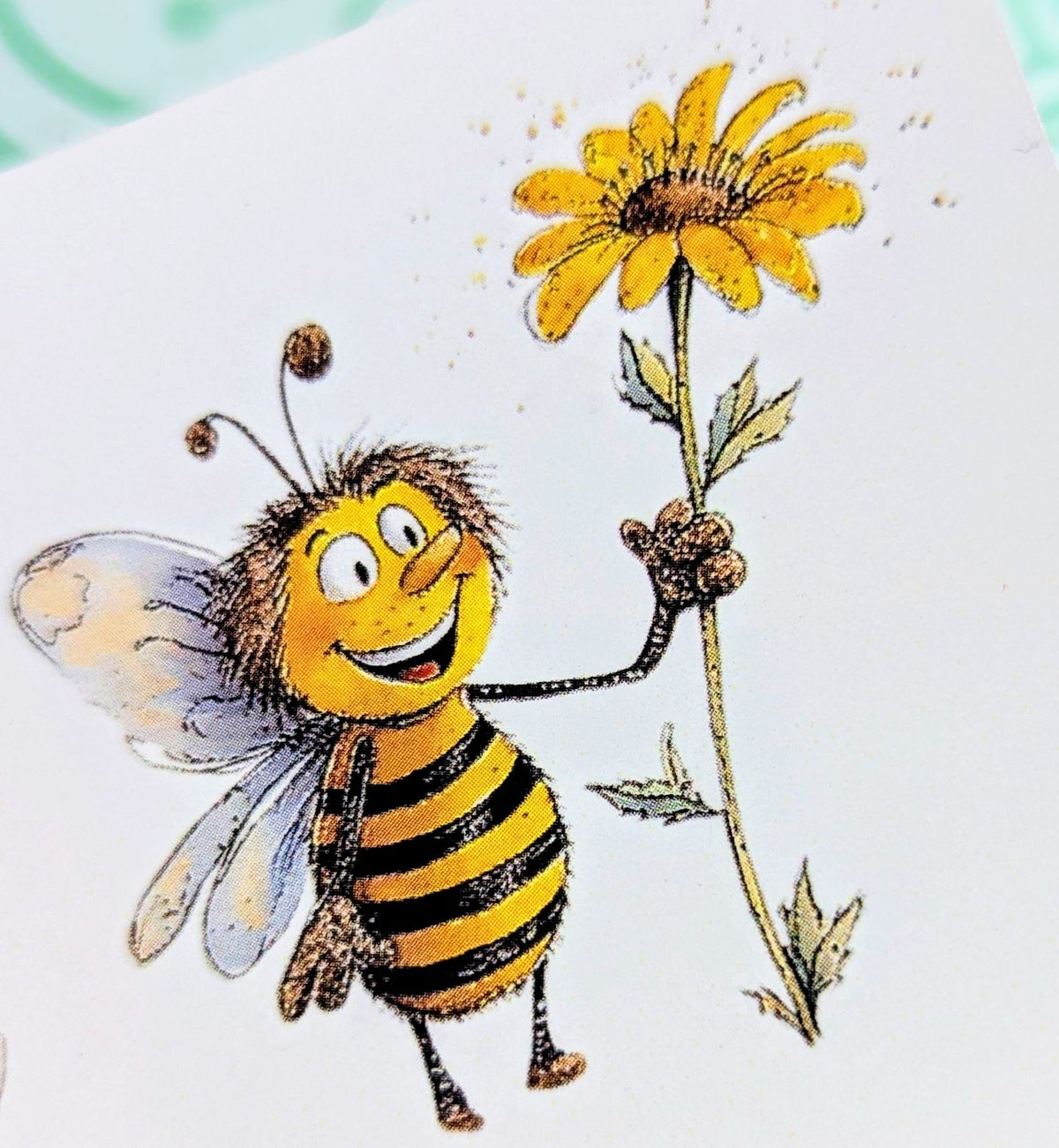 Happy cartoon bee holding a daisy printed waterslide decal