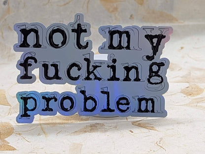 Not My Fucking Problem holographic vinyl sticker, alternate angle showing color shift - SoCuteINeedOneToo