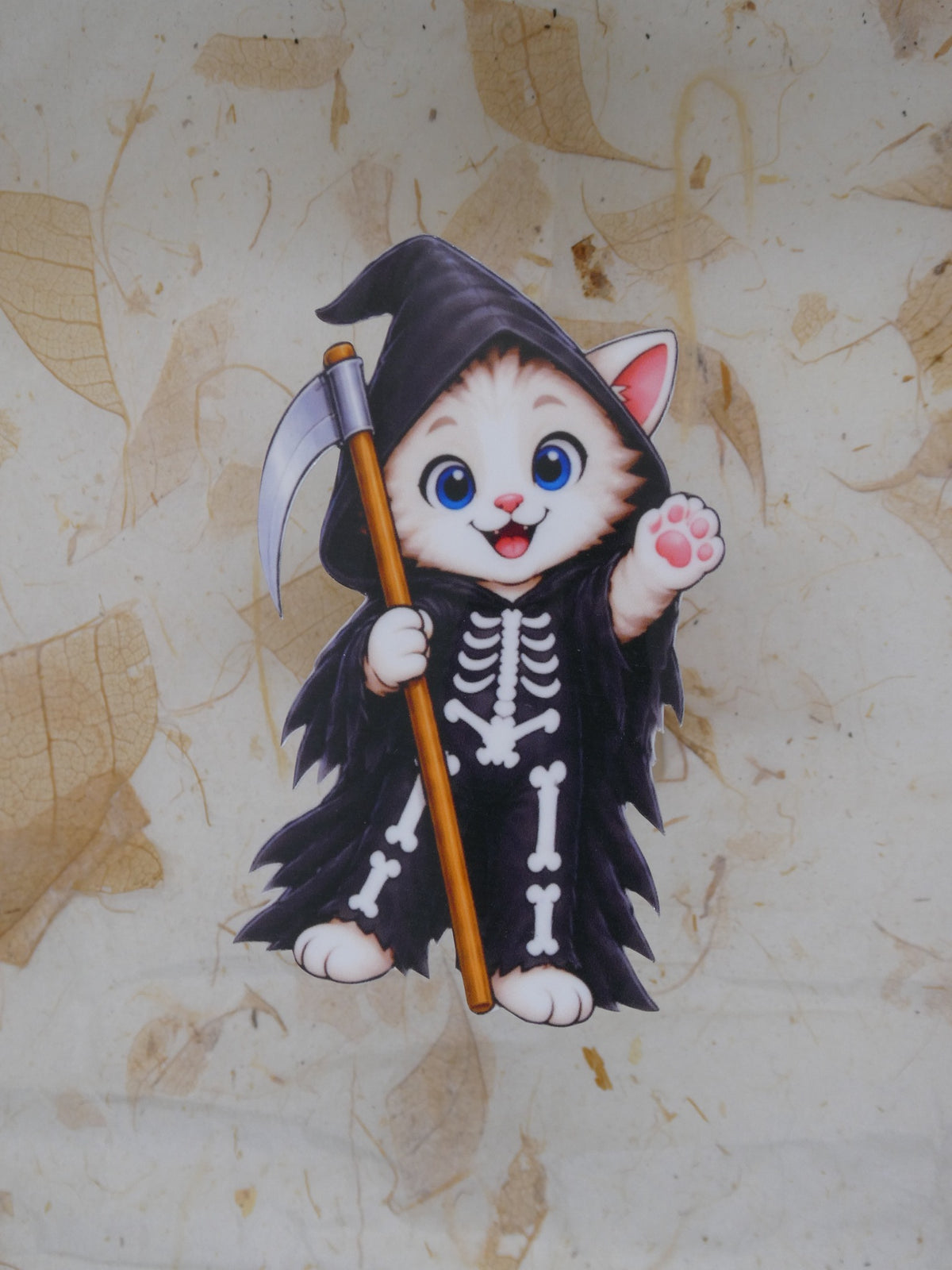 Grim Reaper Bobcat Halloween sticker - kitten in a black skeleton robe with scythe