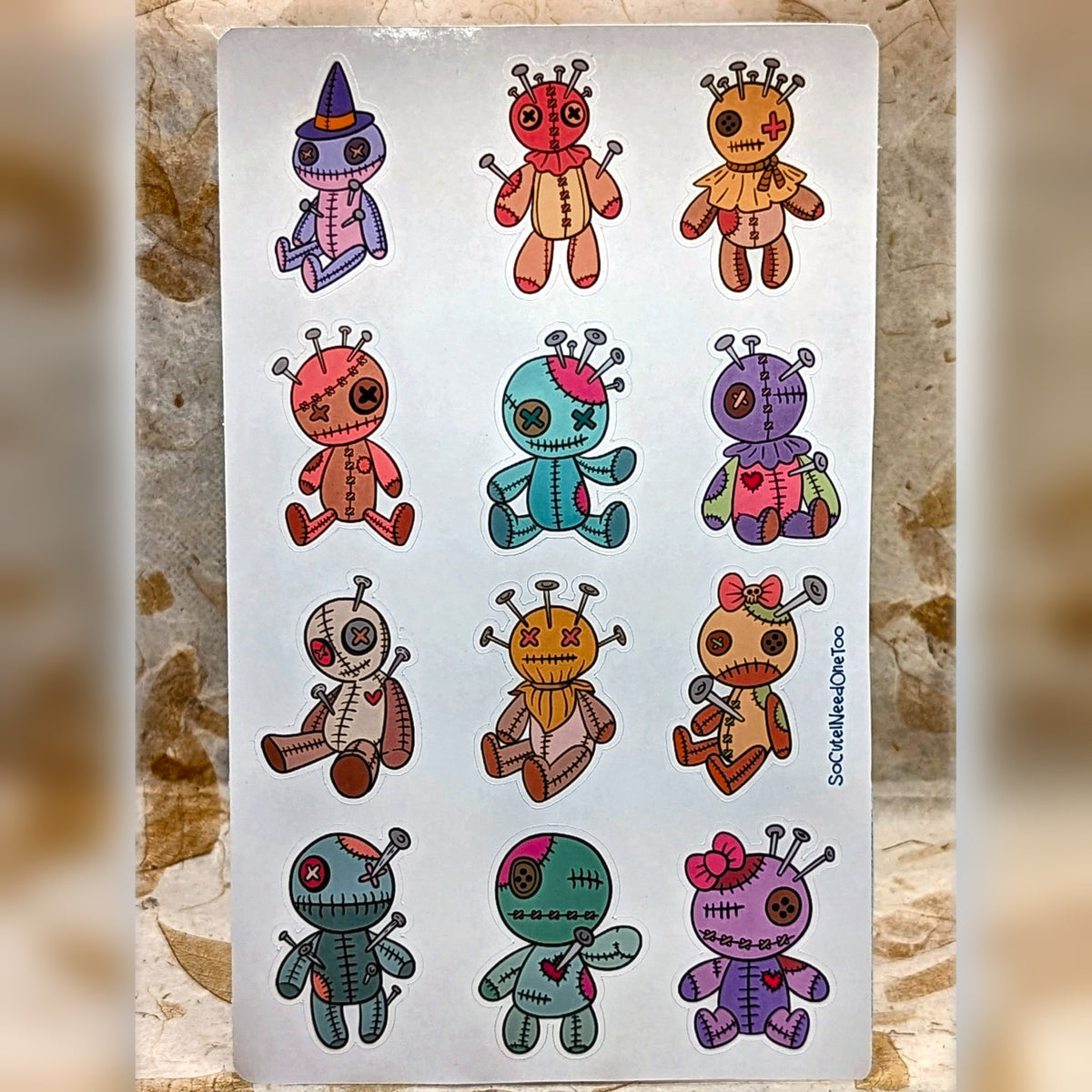 Half sheet of 12 pastel patchwork voodoo doll stickers, real product photo